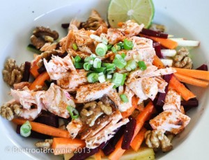 Salmon with raw vegetable strips, walnuts and spring onions